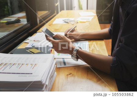 Businessman using smart phone on his plan project. 105503862