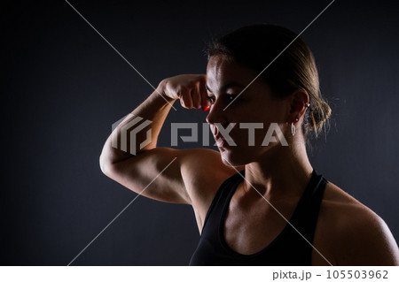 Portrait of a female mixed martial arts fighter with a bandage and gloves on her hands. Portrait of a female mixed martial arts fighter with a bandage and gloves on her hands. 105503962
