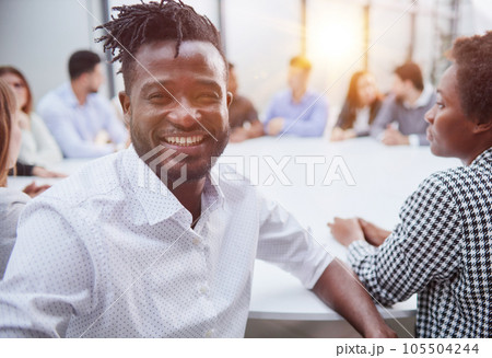 Business Leadership. Serious businessman standing in front of his business team in a modern office. Business Leadership. Serious businessman standing in front of his business team in a modern office. 105504244