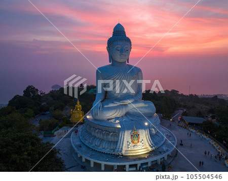 aerial view Phuket big Buddha in beautiful sunset. the sun shines through the clouds impact on ocean surface The beauty of the statue fits perfectly with the charming nature. cloud scape background. 105504546