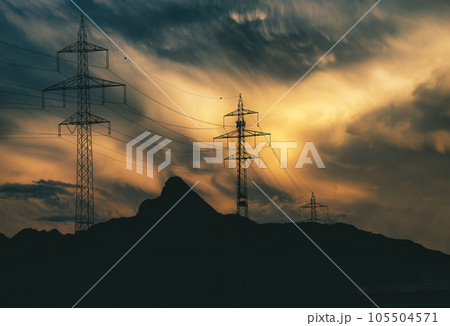 High-tension pylons in the mountains 105504571