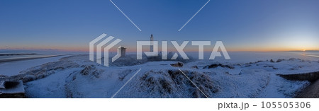 Panorama over the dunes and lighthouse of the Danish coastal resort of Blavand at sunrise Panorama over the dunes and lighthouse of the Danish coastal resort of Blavand at sunrise 105505306