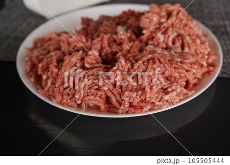A bowl of Minced meat on black background A bowl of Minced meat on black background 105505444