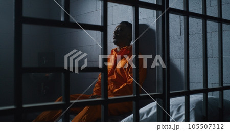 Guilty prisoner sits and thinks about freedom 105507312