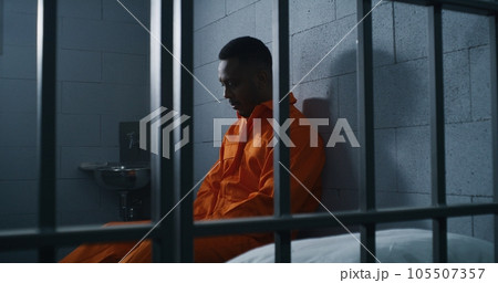 Guilty prisoner sits and thinks about freedom Guilty prisoner sits and thinks about freedom 105507357