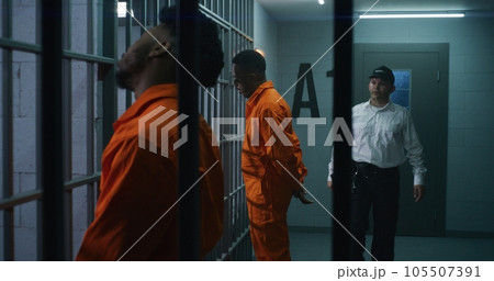 Criminals stand face to cell with hands behind Criminals stand face to cell with hands behind 105507391