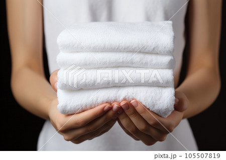 A woman holds white towels A woman holds white towels 105507819