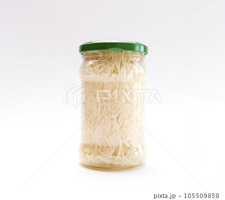 Real Isolated Celery Root Salad Preserve In Glass Jar With Screw Metal Cap On White Background. Shredded And Pickled Celery Crops, Tuber. Apium Graveolens, Culinary. Horizontal Plane 105509858