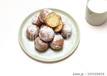 Flatly Fat Thursday Carnival or Tlusty Czwartek, Christian tradition. Zeppole Or Paczki On Plate With Powdered Sugar, Cup Of Milk On Table. Doughnut, Delicious Donuts. Horizontal Plane 105509859