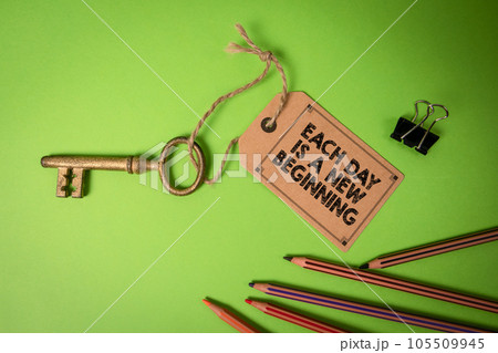 EACH DAY IS A NEW BEGINNING. Cardboard price tag with text on a green background 105509945