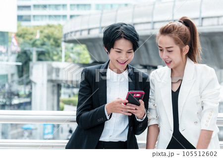 Business Woman Partner talk, meeting team Partnership in modern city together. Diversity Asian Business Partner online meeting trust teamwork. Asian Two Business people teams meeting outdoor in city. 105512602