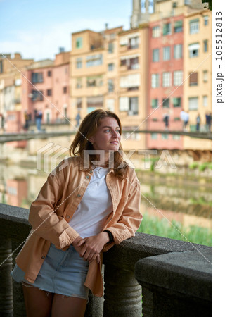 Tourist beautiful woman in Girona, Catalonia, Spain near of Barcelona. Famous resort destination in Costa Brava. Portrait of sexy woman posing at the town. Beautiful girl on the empty street in old 105512813