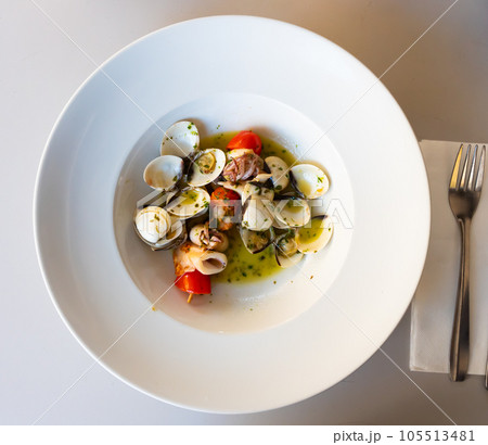 Popular Spanish dish Squid on a skewer with garlic Popular Spanish dish Squid on a skewer with garlic 105513481
