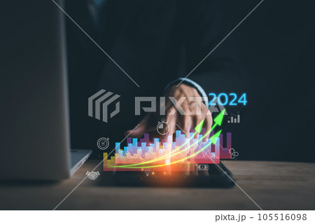Business growing in 2024. Businessman hand typing laptop and tablet with virtual increasing technical graph and up arrow for trader analysis. Stock, Cryptocurrency chart trader, trading, investment. Business growing in 2024. Businessman hand typing laptop and tablet with virtual increasing technical graph and up arrow for trader analysis. Stock, Cryptocurrency chart trader, trading, investment. 105516098