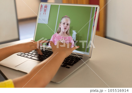 Mid section of a boy using laptop while having a video call with caucasian girl at home 105516914