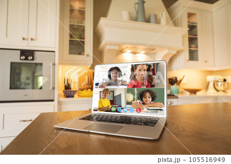 Laptop with video conference with diverse students on a table in the kitchen Laptop with video conference with diverse students on a table in the kitchen 105516949