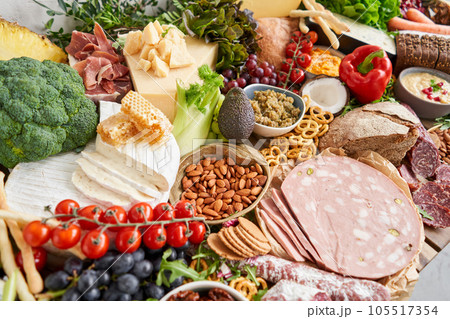 Fresh bread, pastries. Table full of mediterranean appetizers, tapas or antipasto. Assorted Italian food set. Delicious snack on party or picnic time. Italian style banquet.  105517354