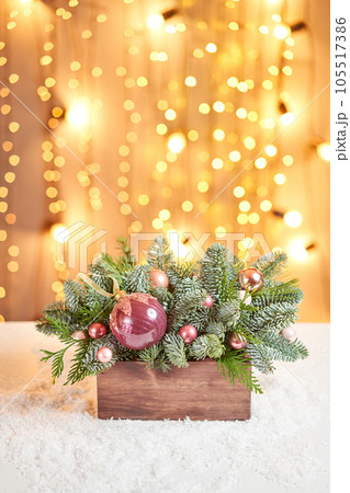 Floral arrangement with live spruce for decorating the house for the Christmas holidays. Christmas wooden box with fir branches for the holiday. The new year celebration. European flower shop 105517386