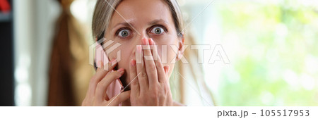 Stressed and shocked woman talking on smartphone and looking at camera. Stressed and shocked woman talking on smartphone and looking at camera. 105517953
