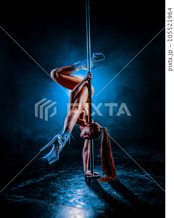 Young woman pole dancing 105521964