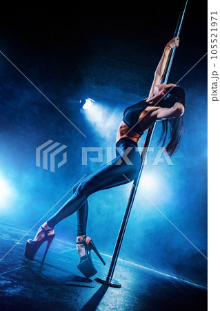 Young woman pole dancing 105521971