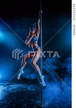Young woman pole dancing 105522234