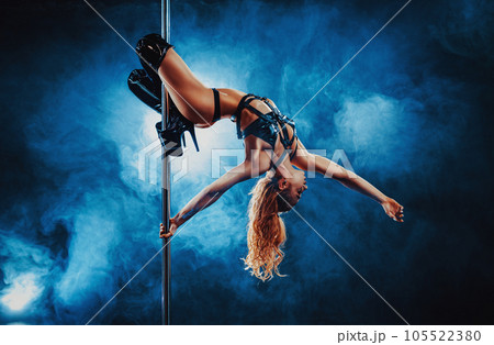 Young woman pole dancing Young woman pole dancing 105522380