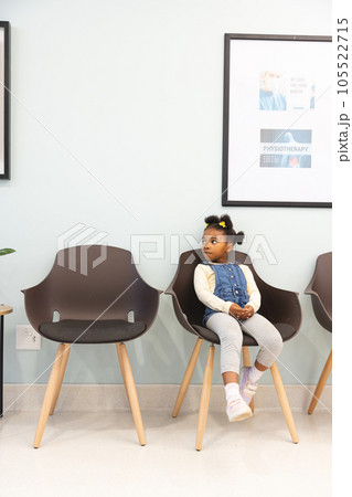 African american girl patient sitting in waiting room at hospital, copy space African american girl patient sitting in waiting room at hospital, copy space 105522715