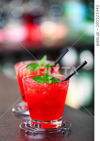 Two Mai Tai cocktail shot on a bar counter in a nightclub. Vertical shot 105523341