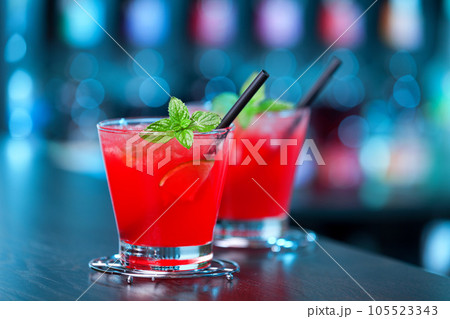 Two Mai Tai cocktail shot on a bar counter in a nightclub. Vertical shot 105523343