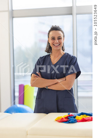 Portrait of happy female caucasian physiotherapist wearing scrubs at hospital Portrait of happy female caucasian physiotherapist wearing scrubs at hospital 105523649