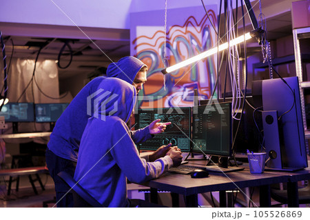 Hackers cracking strong password and checking ransomware code on computer screen. Criminals running malicious software to break into database server and steal privacy information 105526869