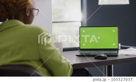Business manager looking at pc with green screen, using isolated mockup display in agency office. Corporate employee checking chroma key copyspace template at executive startup job. Business manager looking at pc with green screen, using isolated mockup display in agency office. Corporate employee checking chroma key copyspace template at executive startup job. 105527037