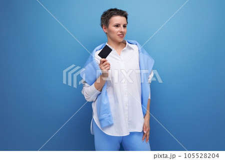 stylish young brunette woman with short haircut uses card to pay for shopping 105528204