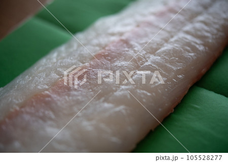 天然ヒラメの柵をドリップシートで包む 105528277