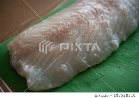 天然ヒラメの柵をドリップシートで包む 105528310