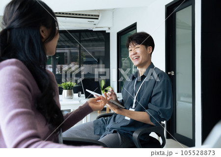 employee discuss business income report in tablet together in the office employee discuss business income report in tablet together in the office 105528873