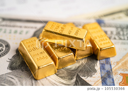 Gold bar on US dollar banknotes money and graph, economy finance exchange trade investment concept. Gold bar on US dollar banknotes money and graph, economy finance exchange trade investment concept. 105530366