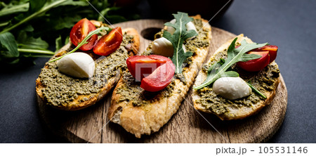 Bruschettas with pesto and tomatoes 105531146