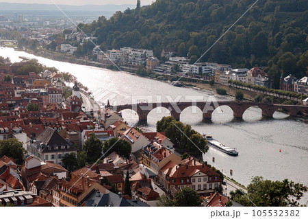 Aerial drone view over famous city of Heidelberg Germany with bridge on river Neckar. Dramatic cloudy sky with sunbeams over old town and mountains Aerial drone view over famous city of Heidelberg Germany with bridge on river Neckar. Dramatic cloudy sky with sunbeams over old town and mountains 105532382