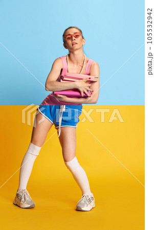 Collage with combination portraits of young beautiful girl with pink glasses and books wearing sportswear and elegant dress over blue and yellow background Collage with combination portraits of young beautiful girl with pink glasses and books wearing sportswear and elegant dress over blue and yellow background 105532942