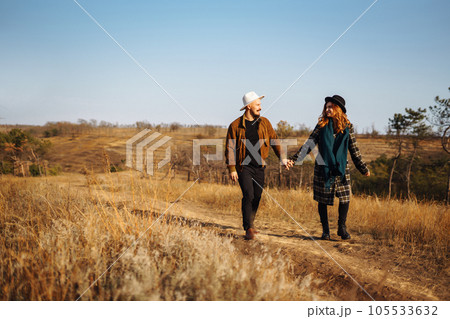 Lovely hipster couple enjoying each other in the autumn park. Nice autumn day. love and lifestyle. Lovely hipster couple enjoying each other in the autumn park. Nice autumn day. love and lifestyle. 105533632