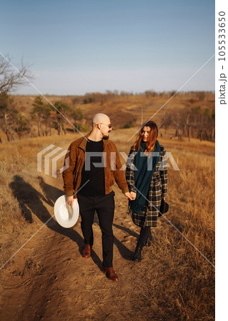 Lovely hipster couple resting in nature. People, lifestyle, relaxation and vacations concept. 105533650