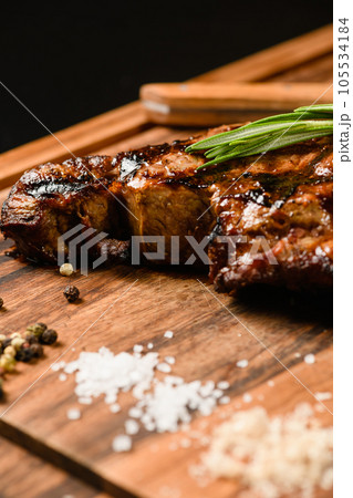Appetizing juicy steak on a wooden cutting board. Appetizing juicy steak on a wooden cutting board. 105534184