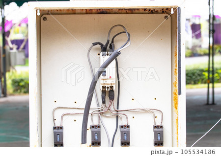 Box old small breaker electrical is damaged broken show circuit board attached to concrete pole. Main substation power button to distribute electricity supply. Temporary distribution electric control. Box old small breaker electrical is damaged broken show circuit board attached to concrete pole. Main substation power button to distribute electricity supply. Temporary distribution electric control. 105534186