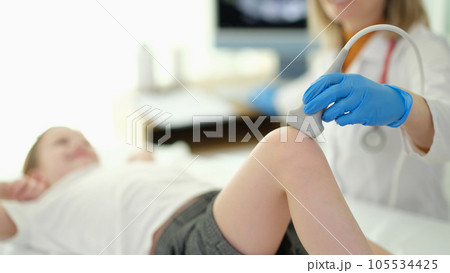 Girl child with orthopedic doctor medical ultrasound of knee 105534425