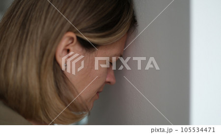 Desperate woman blunts against wall and worrying about problems at work 105534471