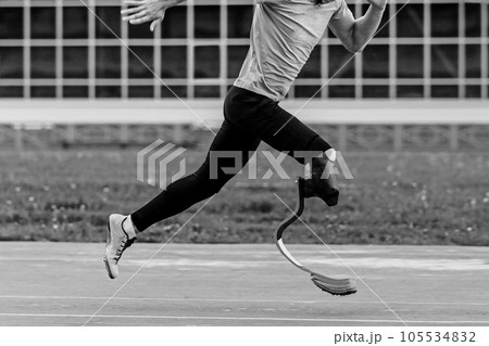 para-athlete running sprint race at athletics competition, black and white photo 105534832