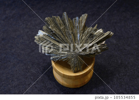 Clouse-up of the gray antimonite mineral from the eastern Ukraine, on a blue background 105534855