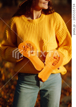 Young woman in a yellow sweater and jeans resting in nature. Fashion, style concept. People, lifestyle. 105535734